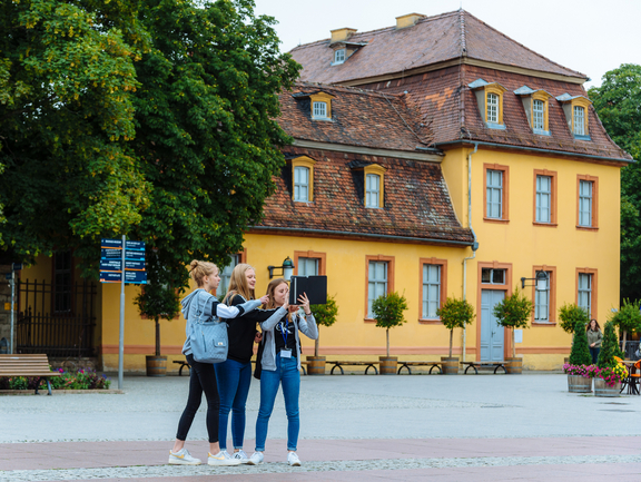 Unterwegs für kreative Aufnahmen Drei Mädchen stehen auf dem Theaterplatz vor dem Wittumspalais und nehmen mit dem Tablet Fotos auf.