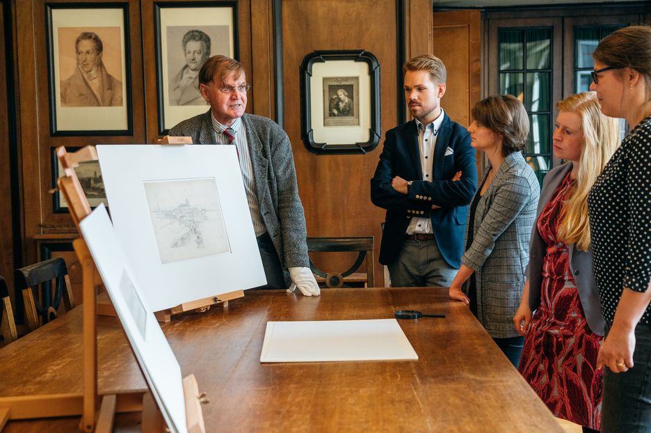 Research A member of staff from the Prints and Drawings Department presents a print.